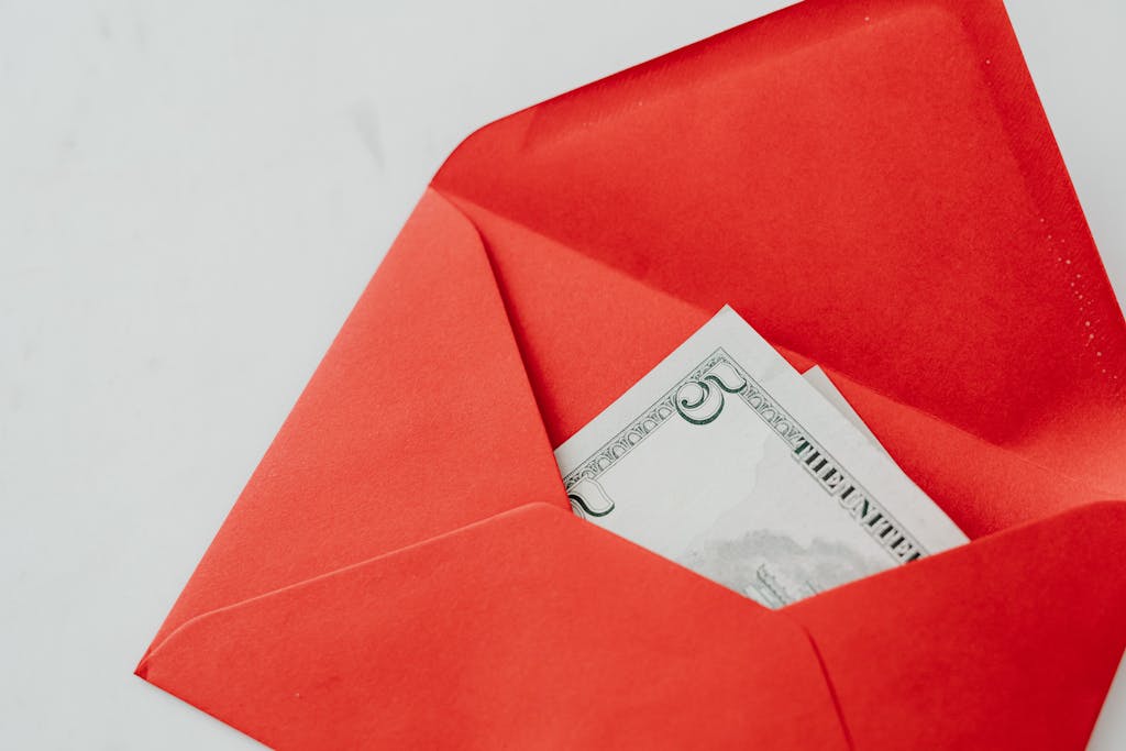 A red envelope containing a five dollar bill, perfect for gifts or special occasions.