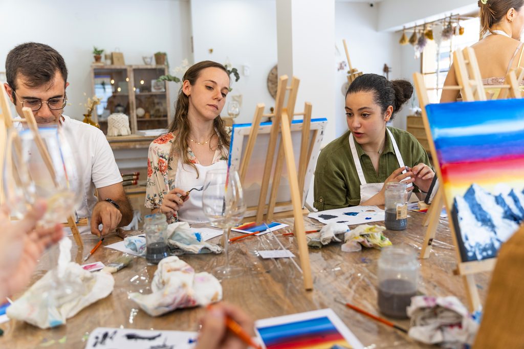 friends meeting for an art class, painting canvas.