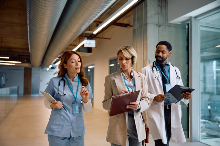 healthcare system, hospital hallway, medical staff discussing healthcare grants