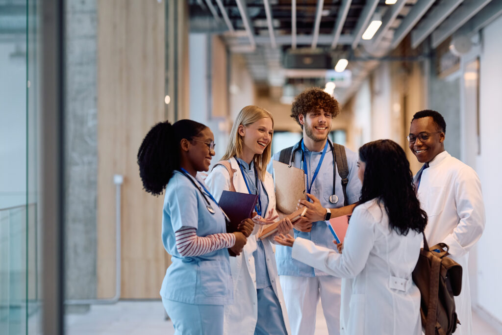 Group of medical and healthcare professionals talking in hallway